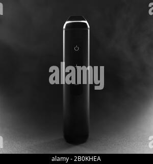 Electronic cigarette pen on smokey dark background Stock Photo