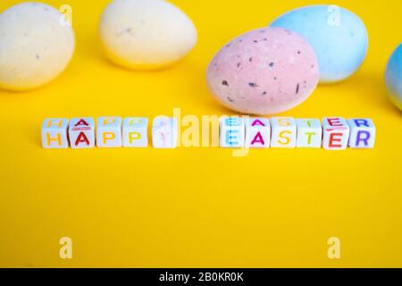 Easter greeting card with painted eggs. Seasonal Easter message "Happy easter". Pastel and colorful decorated easter eggs with greeting card with text Stock Photo