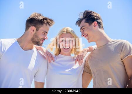 Member friendship wishes to enter into romantic relationship. Friendship love. Friend zone concept. Happy together. Cheerful friends. Friendship relations. People outdoors. Happy woman and two men. Stock Photo