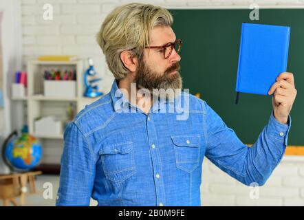 persistence concept. use notebook or book. back to school. literature and language learning. strict teacher in glasses. teacher check knowledge. are you ready for exam test. man tutor in classroom. Stock Photo