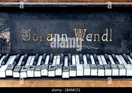 Old abandoned broken Johann Wendl piano, damaged piano keys Stock Photo