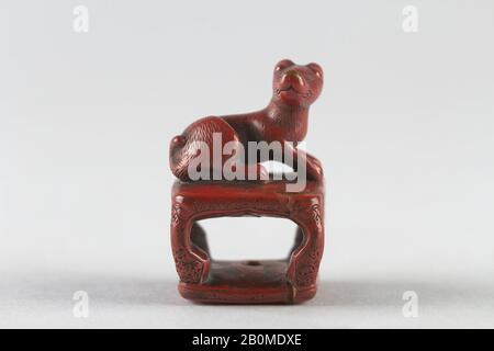 Netsuke of Dog on a Stand, Japan, 19th century, Japan, Red lacquer, H. 1 1/2 in. (3.8 cm); W. 1 in. square (2.5 cm), Netsuke Stock Photo