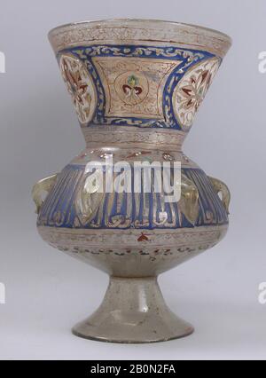 Mosque lamp, 14th century, Attributed to Egypt or Syria, Glass, colorless with brownish tinge; free blown; enameled with red, blue, white, yellow, and green; gilded; six loops for suspension and foot attached., H. 11 1/16 in. (28.1 cm), Max. Dia. 7 5/16 (18.6 cm), Glass Stock Photo