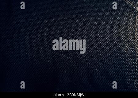 Black dramatic synthetic dark fabric textured background Stock Photo