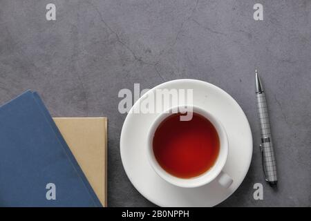 top view of tea and stack of books on table  Stock Photo