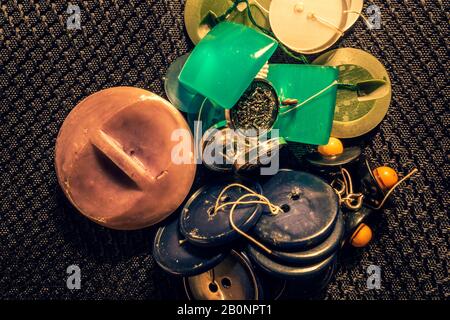 abstract sewing buttons and beads on black background Stock Photo
