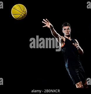 one caucasian young basketball player man in studio isolated on black background Stock Photo