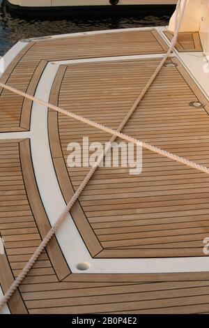 Motorboat stern with timber decking and crossed ropes Stock Photo