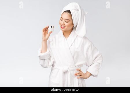 Beauty concept. Asian pretty woman with perfect skin holding cosmetic bottle. Stock Photo