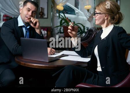 Happy business people working together on laptop Stock Photo