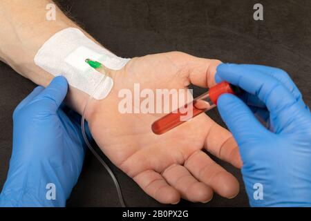 Medical worker holding test tube with blood plasma Stock Photo