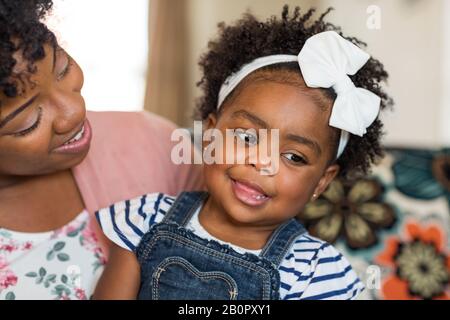 African American family. Mother and daughter smiling at home. Stock Photo