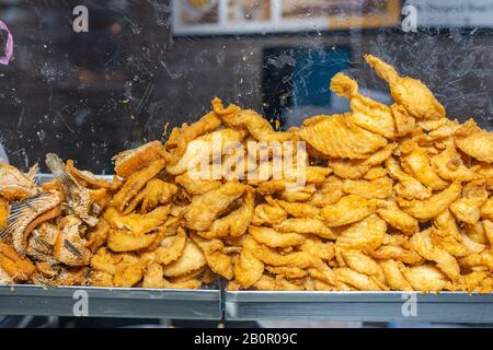 Heap of deep-fried crispy fish fillet for sale in showcase  Stock Photo