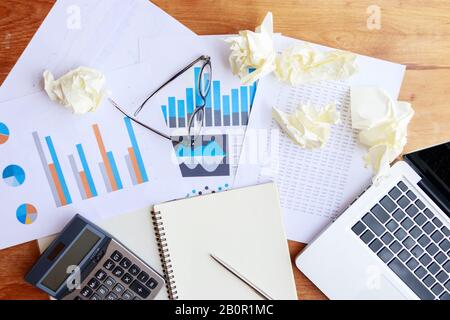 accounting, banking and statistic data concept. accounting work space with calculator, profit paper work and computer on wooden tables, top view Stock Photo