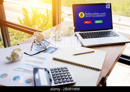 computer tablet with screen for buy or sell bitcoin on workspace table in modern office ,bitcoin electronic money concept. Stock Photo