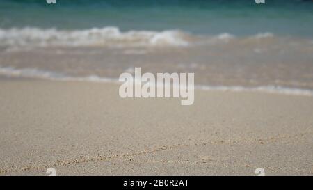 soft wave of the blue sea , clear water on the white sand beach with copy space area. summer sea sandy beach for holiday background wallpaper Stock Photo