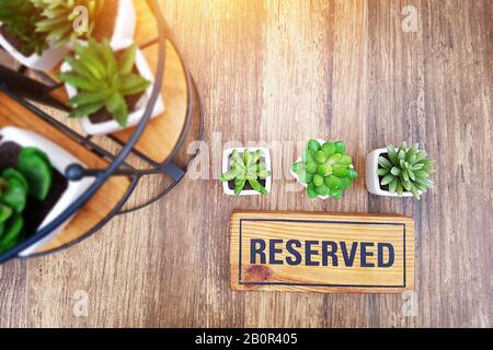 reserved sign on top of a wooden table in a restaurant, reservation seat at restaurant for dating on celebrate day concept, restaurant with reserved Stock Photo