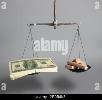 Mortgage business concept. Investment in goods or real estate. On different scales, money and building materials. Stock Photo