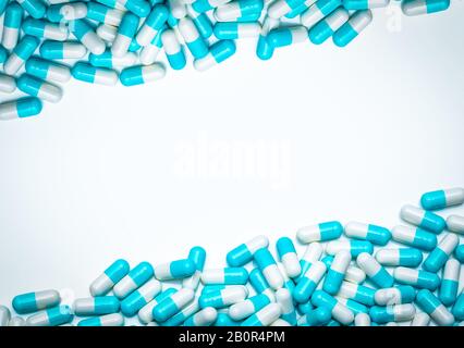 Blue-white antibiotic capsule pills on white background. Antibiotic drug resistance concept. Pharmaceutical industry. Antimicrobial medicine. Pharmacy Stock Photo