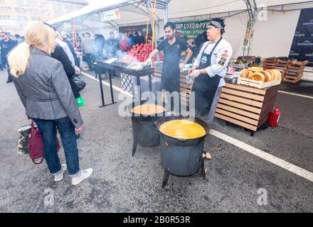 Samara, Russia - October 5, 2019: Cooking appetizing traditional fast food in a large cauldron outdoors during the holiday Stock Photo