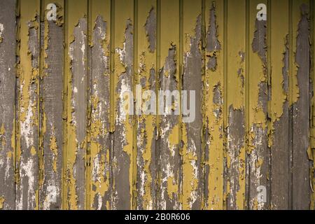 Texture of an old garage losing the yellow and green paint Stock Photo