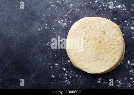 Tortillas, flat breads on dark grey background. Copy space. Top view. Stock Photo