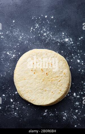 Tortillas, flat breads on dark grey background. Copy space. Top view. Stock Photo