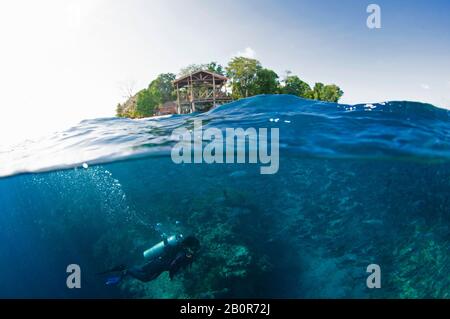 Scuba diver on a coral reef off Sipadan Island, Malaysia Stock Photo