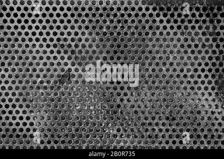 metal old background with holes holes. texture black and white Stock Photo