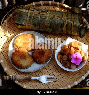 Close up of Vietnamese traditional food for Tet holidays, delicious fried glutinous rice cake on plate on wooden background for breakfast Stock Photo