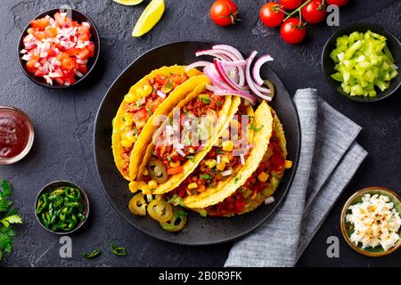 Taco with beef. Mexican traditional cuisine. Dark background. Top view.