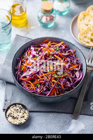Red cabbage salad, Coleslaw in a bowl. Grey background. Stock Photo