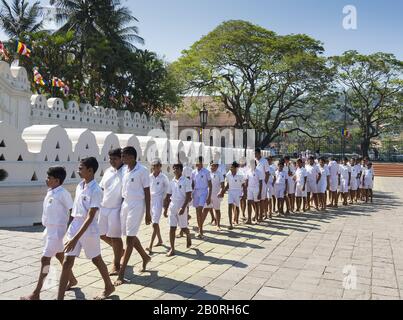 Kandy, Sri Lanka: 03/19/2019: Sri Dalada Maligawa Buddhist shrine. School children visiting. Stock Photo