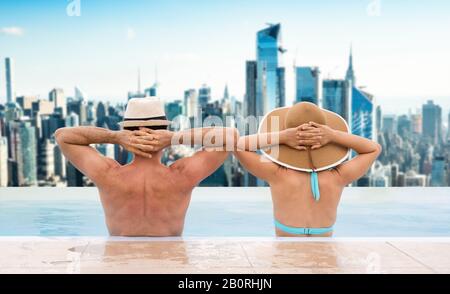 Couple In Infinite Swimming Pool With Dubai Skyline In Background Stock Photo