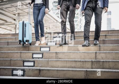 Business people walking down the stairs. On the way back from work quickly. Stock Photo