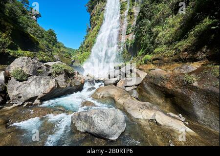 Sagada, Mountain Province, Philippines: Scenic wide angle view of Bomod-ok Waterfalls, Banga-an, surrounded by lush vegetation Stock Photo