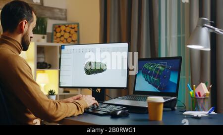 Handsome engineer in his home office developing a new turbine. Creative freelancer. Stock Photo