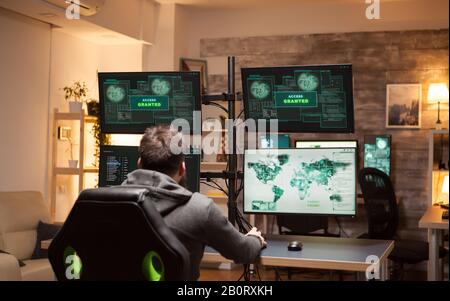 Dangerous hacker happy after gets access granted after a cyber attack. Stock Photo