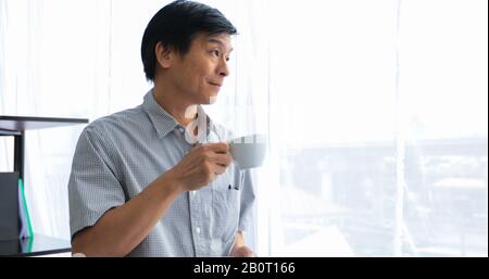 Senior Asian man drinking coffee on relaxing time Stock Photo