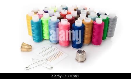 tailor needles and threads over white background Stock Photo