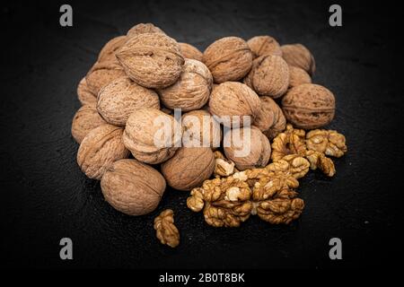 Walnut on over black slate stone background Stock Photo