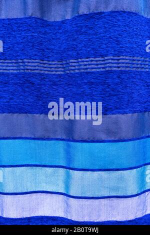 Striped, blue colored, moroccan cactus silk wall hanging, bed cover fabric. Textile industry, handmade fabric background image. Stock Photo