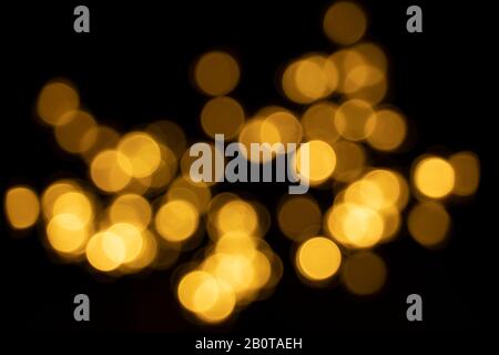 yellow bokeh dots on dark black background Stock Photo