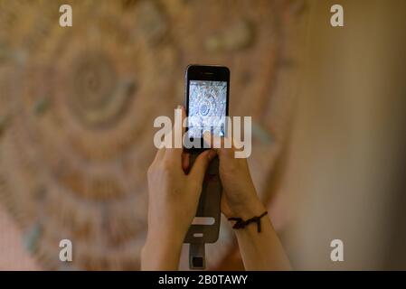 MOSCOW, RUSSIA - JUNE 12, 2017: Tourist taking pictures with smartphone in historical museum. Stock Photo