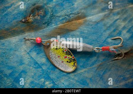 A single vintage fishing lure equipped with treble hooks, possibly by Woods  MFG, on a white background. These types of lures for catching predatory fi  Stock Photo - Alamy