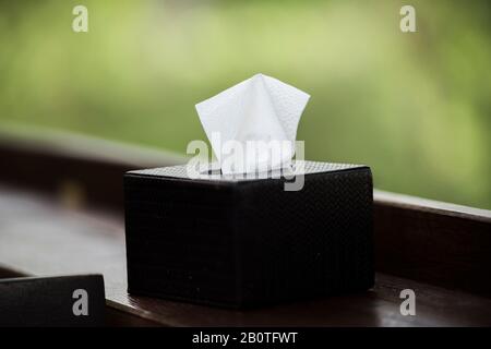 Tissue box black on brown wood bar. Stock Photo