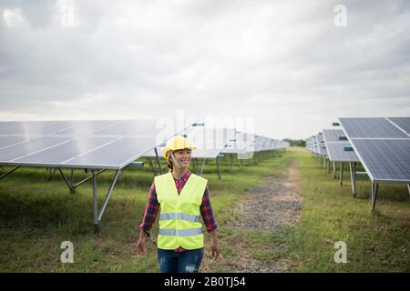 Engineer electric woman checking and maintenance of solar cells. Stock Photo
