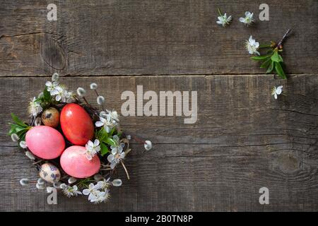 Easter background with  Pink handmade Easter eggs and spring flowers. Top view flat lay background. Copy space. Stock Photo