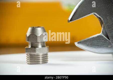 Plumbing pipeline element and adjustable wrench Stock Photo