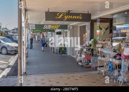 THAMES, NEW ZEALAND - November 07 2019: cityscape of historical village with goods and shop windows under commercial buildings covered walkway on main Stock Photo